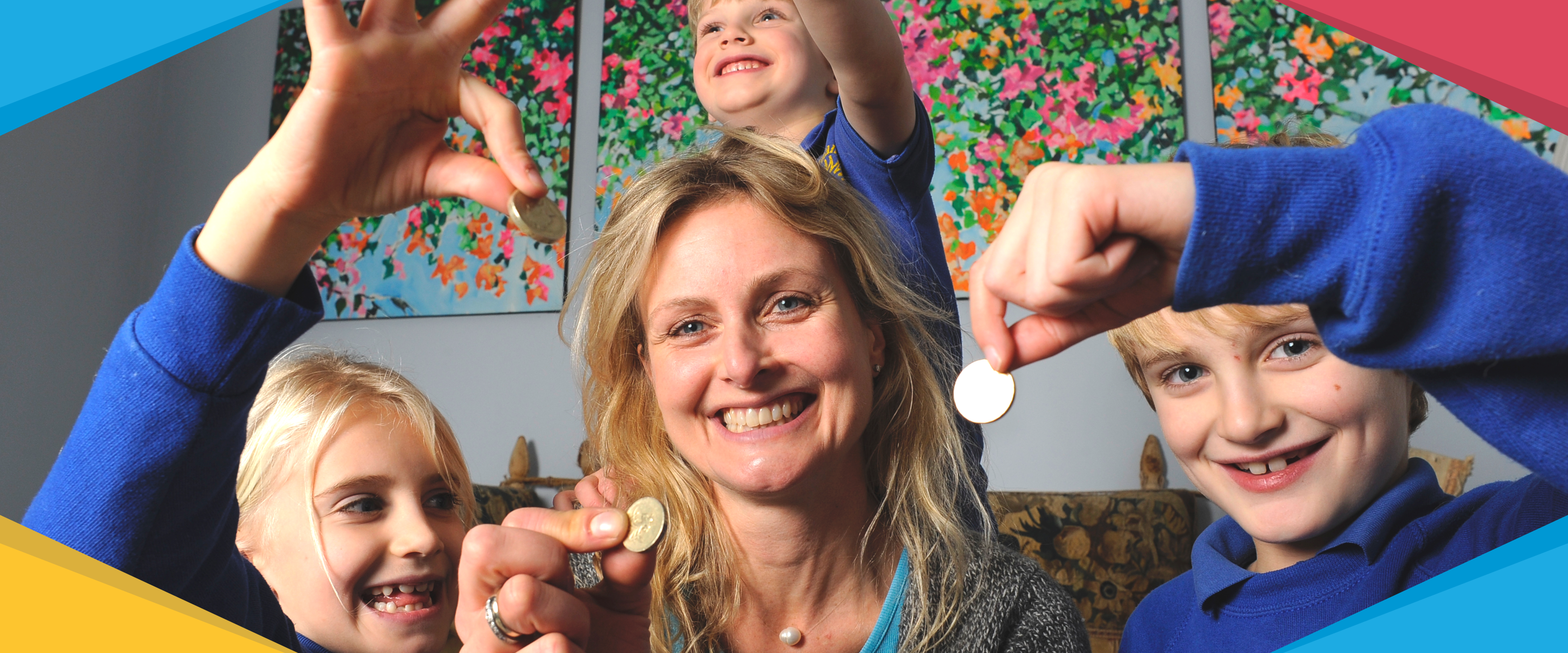 A smiling family of a Mum and three children each holding up a coin, sitting in a living room with origami shapes overlaid decorating the corners