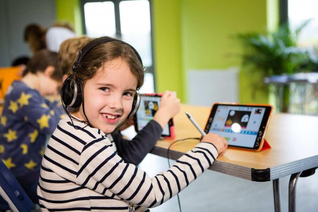 brunette girl playing coding in an app - Roostermoney